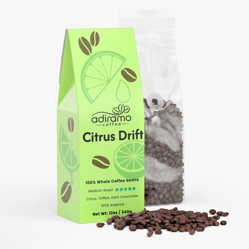 Adiramo Citrus Drift 12oz light green coffee box package with citrus graphics standing beside a clear valve bag of whole coffee beans