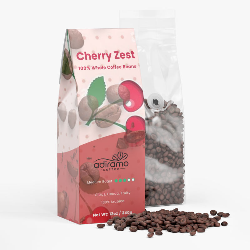 Adiramo Cherry Zest 12oz pink polka dot coffee box package with cherry graphics standing beside a clear valve bag of whole coffee beans
