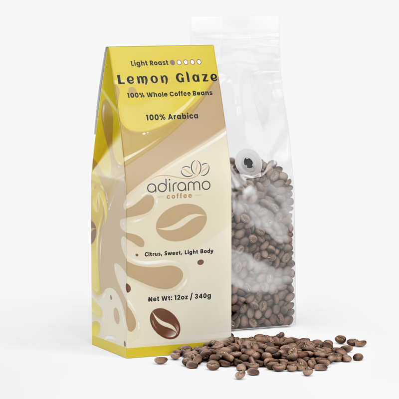 Adiramo Lemon Glaze 12oz light roast coffee retail box with yellow glaze graphics standing beside a clear valve bag of whole coffee beans